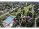 An aerial view featuring community pool, clubhouse, and lush green spaces at 25015 E Park Crescent Dr, Aurora, CO 80016