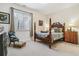 Guest bedroom featuring natural light and a decorative wooden bed frame at 25015 E Park Crescent Dr, Aurora, CO 80016