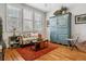 Cozy bedroom with hardwood floors, a comfortable seating area, and ample natural light at 25015 E Park Crescent Dr, Aurora, CO 80016