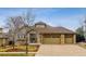 Well-maintained home with stone accents and a three-car garage, offering curb appeal and functionality at 25015 E Park Crescent Dr, Aurora, CO 80016