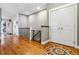 A hallway with hardwood floors, iron railing, and natural light at 25015 E Park Crescent Dr, Aurora, CO 80016