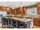 Open kitchen with a large island, stainless steel appliances, and hardwood floors, perfect for entertaining at 25015 E Park Crescent Dr, Aurora, CO 80016