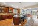 Open-concept kitchen with a large island, hardwood floors, and modern stainless-steel appliances at 25015 E Park Crescent Dr, Aurora, CO 80016