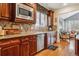 Gourmet kitchen with custom wood cabinetry, granite countertops, and stainless-steel microwave oven at 25015 E Park Crescent Dr, Aurora, CO 80016
