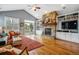 Inviting living room featuring a stone fireplace, built-in shelving, and access to an outdoor balcony at 25015 E Park Crescent Dr, Aurora, CO 80016