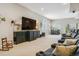 Spacious living room featuring plush seating and a large screen television at 25015 E Park Crescent Dr, Aurora, CO 80016