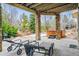 An outdoor patio with stone pillars, lounge chairs, and a hot tub, perfect for relaxation at 25015 E Park Crescent Dr, Aurora, CO 80016