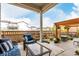 Expansive backyard with a covered patio, outdoor furniture, and manicured landscaping at 21492 E 60Th Ave, Aurora, CO 80111