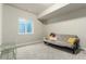 Finished basement with carpeting, window egress, and a gray futon at 21492 E 60Th Ave, Aurora, CO 80111