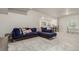 Finished basement area with plush carpeting, a blue sectional and a small wet bar at 21492 E 60Th Ave, Aurora, CO 80111