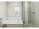 This bath displays an integrated tub and glass shower with designer touches and calming neutral tones at 21492 E 60Th Ave, Aurora, CO 80111