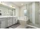 The bathroom boasts a soaking tub, a glass shower, tile surround, and double vanity sinks at 21492 E 60Th Ave, Aurora, CO 80111