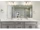 This bathroom includes double sinks with bright counters, gray cabinets and modern lighting at 21492 E 60Th Ave, Aurora, CO 80111