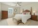 The serene bedroom is decorated with a ceiling fan, neutral decor, and a window that provides natural light at 21492 E 60Th Ave, Aurora, CO 80111