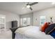 The modern main bedroom is complemented by a large ceiling fan and oversized windows offering great light at 21492 E 60Th Ave, Aurora, CO 80111