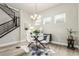 Modern dining area featuring a glass-top table, seating for four, stylish decor, and ample natural light at 21492 E 60Th Ave, Aurora, CO 80111