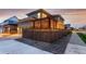 Well-maintained home exterior with a wooden fence and a covered patio at 21492 E 60Th Ave, Aurora, CO 80111