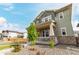 Inviting two-story home with a charming front porch, complemented by a well-manicured lawn and a lovely shade tree at 21492 E 60Th Ave, Aurora, CO 80111