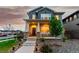 Charming two-story home featuring a welcoming front porch and beautifully landscaped front yard with lovely plantings at 21492 E 60Th Ave, Aurora, CO 80111