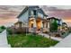 Two-story home with a welcoming front porch, well-maintained lawn, and landscaped yard, perfect for enjoying outdoor living at 21492 E 60Th Ave, Aurora, CO 80111