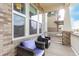 Relaxing front porch showcasing cozy seating, brick accents, and providing a charming spot for outdoor enjoyment at 21492 E 60Th Ave, Aurora, CO 80111