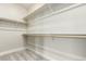 The bare walk-in closet is spacious with storage shelves that allow for ample organization of belongings at 21492 E 60Th Ave, Aurora, CO 80111