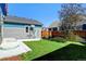 Lush backyard featuring a well-maintained lawn and a privacy fence at 5514 Uinta St, Denver, CO 80238