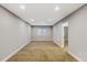 Finished basement space featuring neutral walls, carpet, and ample lighting for various uses at 5514 Uinta St, Denver, CO 80238