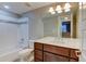 Clean bathroom featuring a vanity with a sink, toilet and shower-tub combination at 5514 Uinta St, Denver, CO 80238