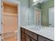 Bright bathroom featuring a tiled shower-tub and a spacious vanity with a large mirror at 5514 Uinta St, Denver, CO 80238