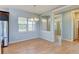 Bright dining area features hardwood floors, stylish lighting, and large windows for natural light at 5514 Uinta St, Denver, CO 80238