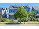 Charming blue two-story home featuring solar panels, a welcoming front porch, and a well-maintained front yard at 5514 Uinta St, Denver, CO 80238