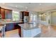 Bright kitchen featuring dark cabinetry, modern appliances and an expansive breakfast bar at 5514 Uinta St, Denver, CO 80238