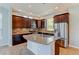 Modern kitchen with stainless steel refrigerator, large island, and sleek countertops at 5514 Uinta St, Denver, CO 80238