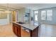 Kitchen island with sink and stainless steel appliances in a modern, open layout at 5514 Uinta St, Denver, CO 80238