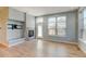 Bright living room with hardwood floors, fireplace, and large windows at 5514 Uinta St, Denver, CO 80238