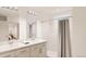 Bathroom featuring double vanity, shower with curtain, and natural light at 22363 E 38Th Pl, Aurora, CO 80019