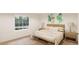 Cozy bedroom with a large window, neutral decor, and bedside tables with lamps at 22363 E 38Th Pl, Aurora, CO 80019