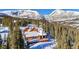 Stunning aerial view of home nestled among snow-covered mountains and evergreen trees at 384 Camron Ln, Breckenridge, CO 80424
