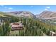 Beautiful mountain home with a deck surrounded by lush trees and breathtaking mountain views at 384 Camron Ln, Breckenridge, CO 80424