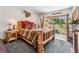 Bedroom showcasing log bed, rustic decor, with doors leading to a patio offering mountain views at 384 Camron Ln, Breckenridge, CO 80424