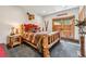 Bedroom showcasing log bed, rustic decor, with doors leading to a patio offering mountain views at 384 Camron Ln, Breckenridge, CO 80424