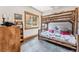 Rustic ' bedroom with a custom wood bunk bed, a window with a mountain view and a wooden dresser at 384 Camron Ln, Breckenridge, CO 80424
