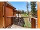 Spacious deck with wood and metal railing overlooking a landscaped yard and views of mountains and trees at 384 Camron Ln, Breckenridge, CO 80424