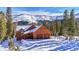 Charming mountain home with a two-car garage surrounded by snow covered trees at 384 Camron Ln, Breckenridge, CO 80424