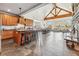 Spacious great room with a kitchen island, stone fireplace, wood beams, vaulted ceilings and mountain views at 384 Camron Ln, Breckenridge, CO 80424