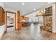 Spacious great room with a kitchen island, stone fireplace, wood beams, vaulted ceilings and mountain views at 384 Camron Ln, Breckenridge, CO 80424