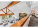 Bright living room featuring exposed beams, a stone fireplace, and outdoor wooded views at 384 Camron Ln, Breckenridge, CO 80424