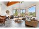 Bright living room with vaulted ceilings, wood beams, comfortable seating and beautiful mountain views from the large windows at 384 Camron Ln, Breckenridge, CO 80424