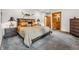 Comfortable main bedroom featuring a rustic decor, gray carpet, and an ensuite bathroom with wood accents at 384 Camron Ln, Breckenridge, CO 80424